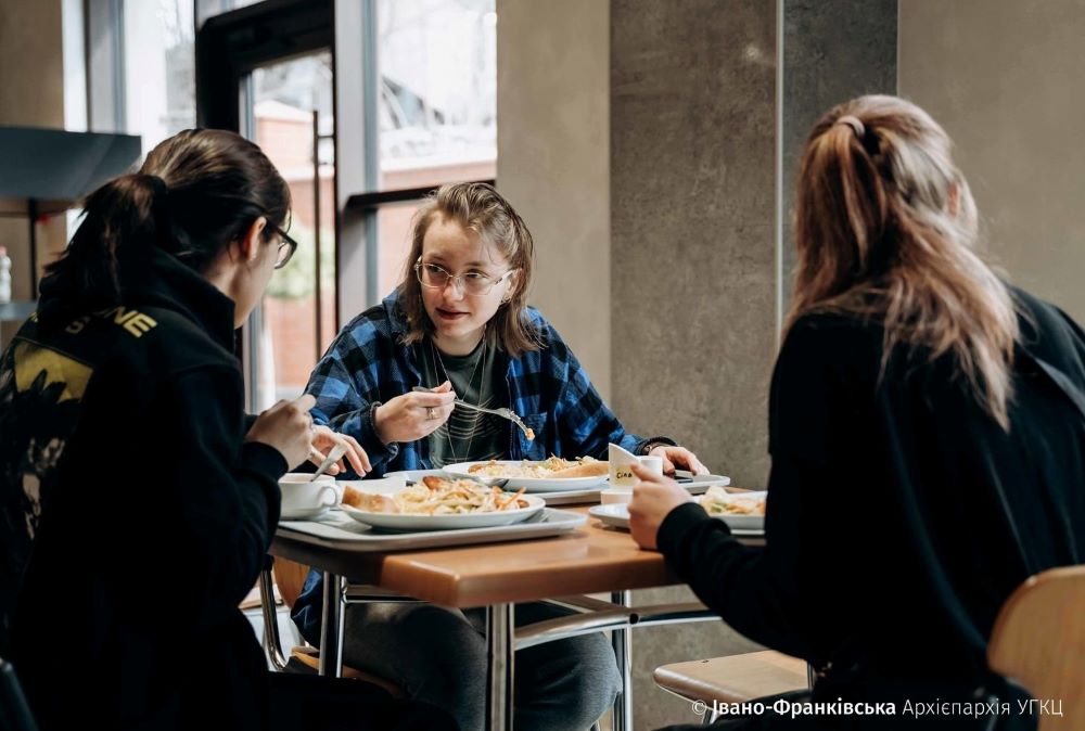 People displaced by the war in Ukraine eat a meal in St. Basil the Great High School in Ivano-Frankivsk in March. (CNS/Courtesy of the Archeparchy of Ivano-Frankivsk)
