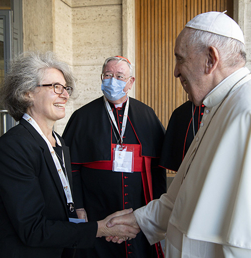 Pope Francis greets Xavière Sr. Nathalie Becquart, undersecretary of the Synod of Bishops, during a meeting with representatives of bishops' conferences from around the world at the Vatican Oct. 9, 2021. (CNS/Paul Haring)