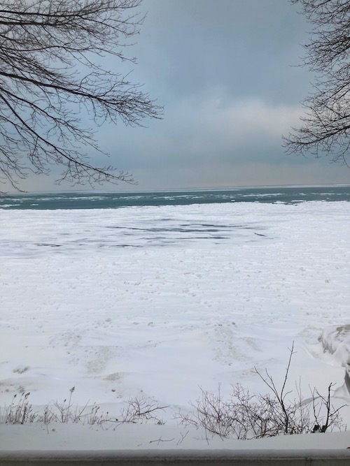 Shoreline of Lake Erie, with snow, sky and bare trees