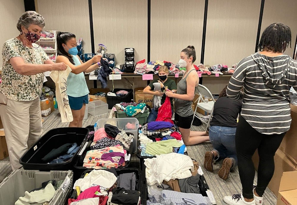 From left: St. Joseph Sr. Louise Ann Micek, Jaesen Evangelista, Emily Michaelis, Emma Shay, Nina Dorsett and Cindy Emenalo. In San Diego, we organized donated clothes for the refugees staying at the migrant hotel.