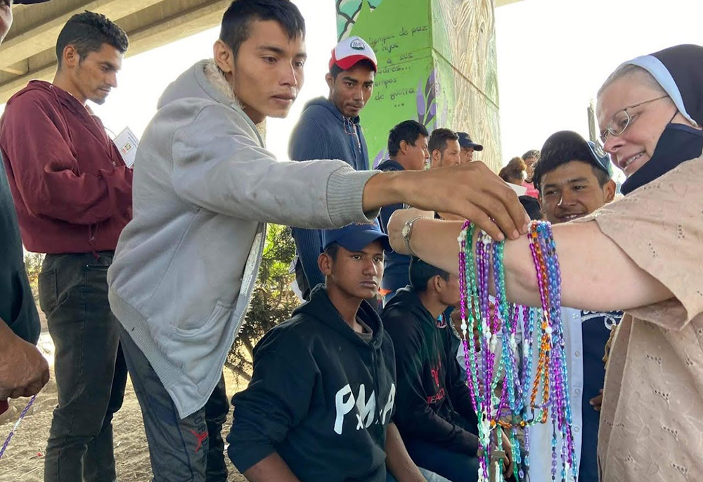 Felician Sr. Maria Louise Edwards passes out a rosary to each migrant, during a presentation at a center, one of 30 migrant shelters in Mexico the team visited to promote its "Education and Awareness Campaign." (Courtesy of Aguilas del Desierto)