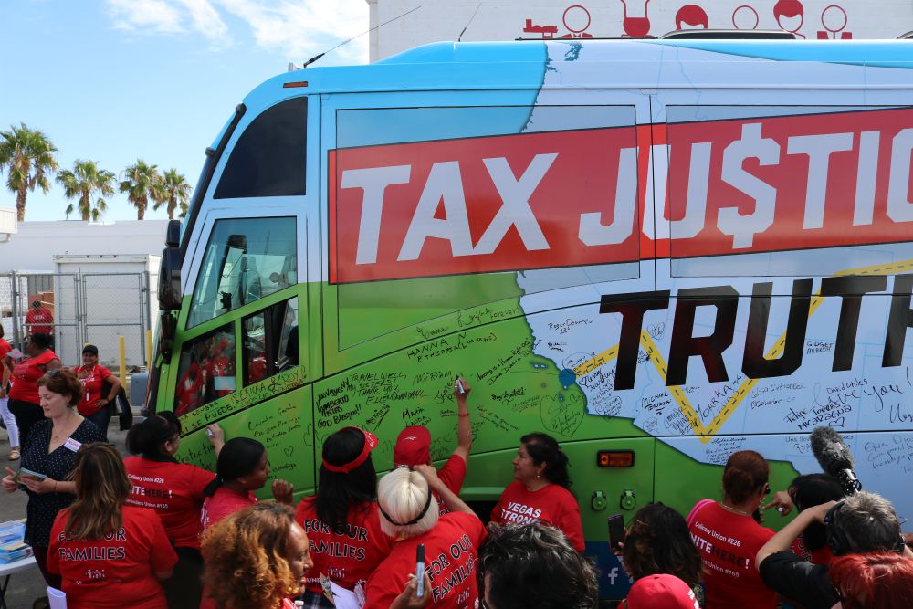 Members of the Culinary Workers Union Local 226 sign the bus after an Oct. 10 canvassing session in Las Vegas (Network Lobby for Catholic Social Justice / Colleen Ross)