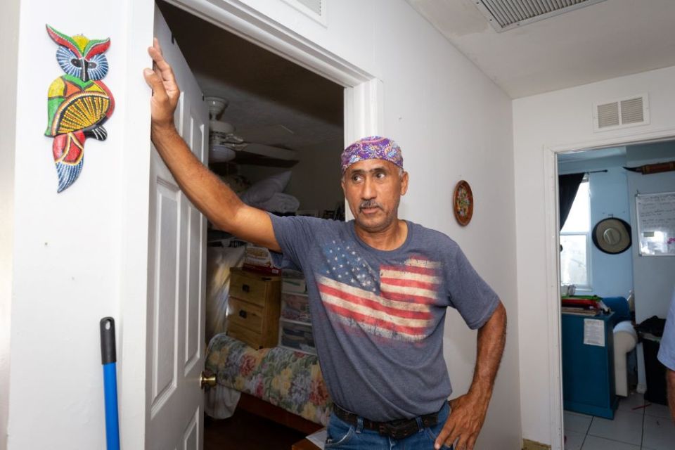 Luis Reyes, an employee of Catholic Charities of the Diocese of Venice, inspects damage to his home in Fort Meyers, Fla., Oct 5, after Hurricane Ian brought at least 3 inches of rain into the residence Sept. 28. (CNS/Tom Tracy)