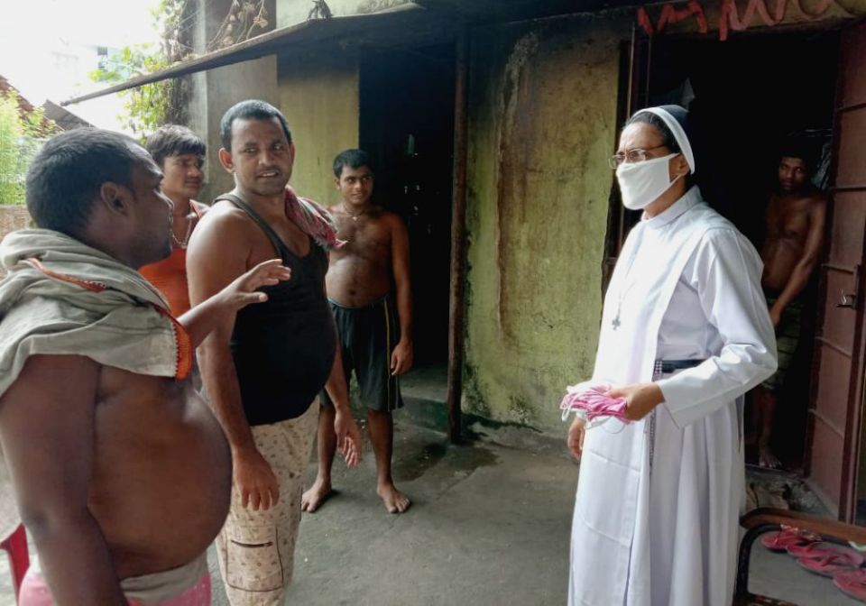 Congregation of Mother of Carmel Sr. Merin Chirackal Ayrookaran gives masks to migrant workers in the southwestern Indian state of Kerala. (Provided photo)