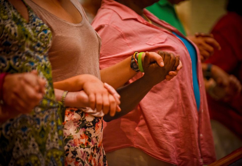 Congregants hold hands and pray during Mass in a 2016 file photo. (CNS/Catholic Herald/Juan C. Medina)