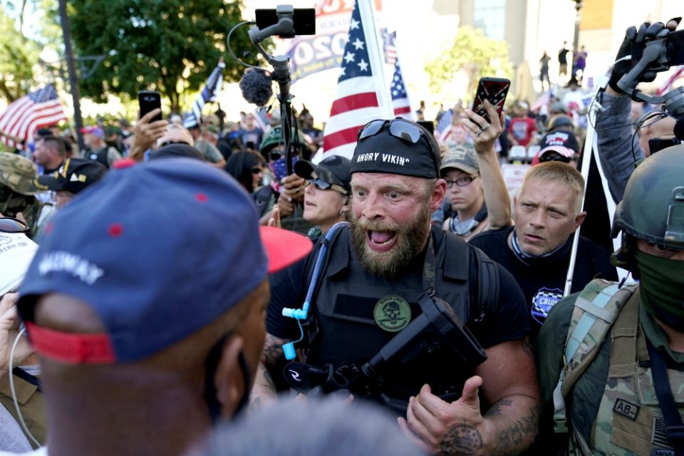 White militia members in Louisville, Kentucky, confront Black Lives Matter activists Sept. 5. (CNS/Reuters/Bryan Woolston) White militia members in Louisville, Kentucky, confront Black Lives Matter activists Sept. 5. (CNS/Reuters/Bryan Woolston)