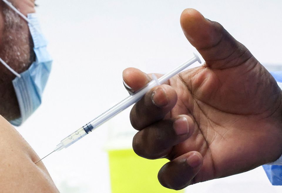 A man receives a booster dose of Pfizer's COVID-19 vaccine in this undated photo. (CNS/Reuters/Yves Herman) A man receives a booster dose of Pfizer's COVID-19 vaccine in this undated photo. (CNS/Reuters/Yves Herman)