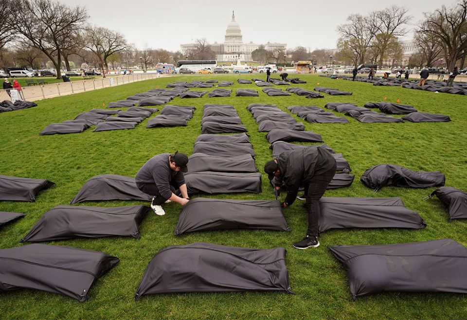 Body bags are placed on the National Mall in Washington near the U.S. Capitol on March 24. (CNS/Reuters/Kevin Lamarque) Body bags are placed on the National Mall in Washington near the U.S. Capitol on March 24. (CNS/Reuters/Kevin Lamarque)