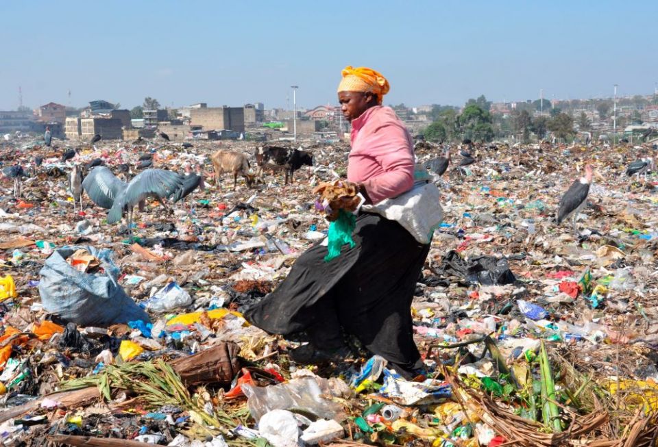 An unidentified woman collects items at the Dandora dumpsite on Feb. 26 in Nairobi, Kenya. The dump attracts poor urban residents who collect recyclable materials for sale. (CNS/Fredrick Nzwili)