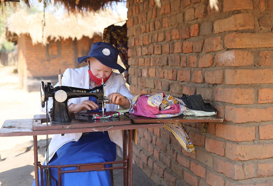 Pemphero Wiladi, 31, operates a sewing machine outside her house in Mtendere. A member of the same clan as Musa Wiladi, she is among thousands of people with albinism who want the Malawi government to protect them from attackers.