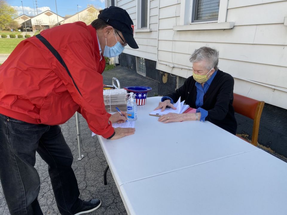 Humility of Mary Sr. Ann McManamon, right, works the voter registration table outside the Dorothy Day House of Hospitality in Youngstown, Ohio. The center set up its table on the sidewalk to register voters three days a week, before the Oct 5 deadline in Humility of Mary Sr. Ann McManamon, right, works the voter registration table outside the Dorothy Day House of Hospitality in Youngstown, Ohio. The center set up its table on the sidewalk to register voters three days a week, before the Oct 5 deadline in