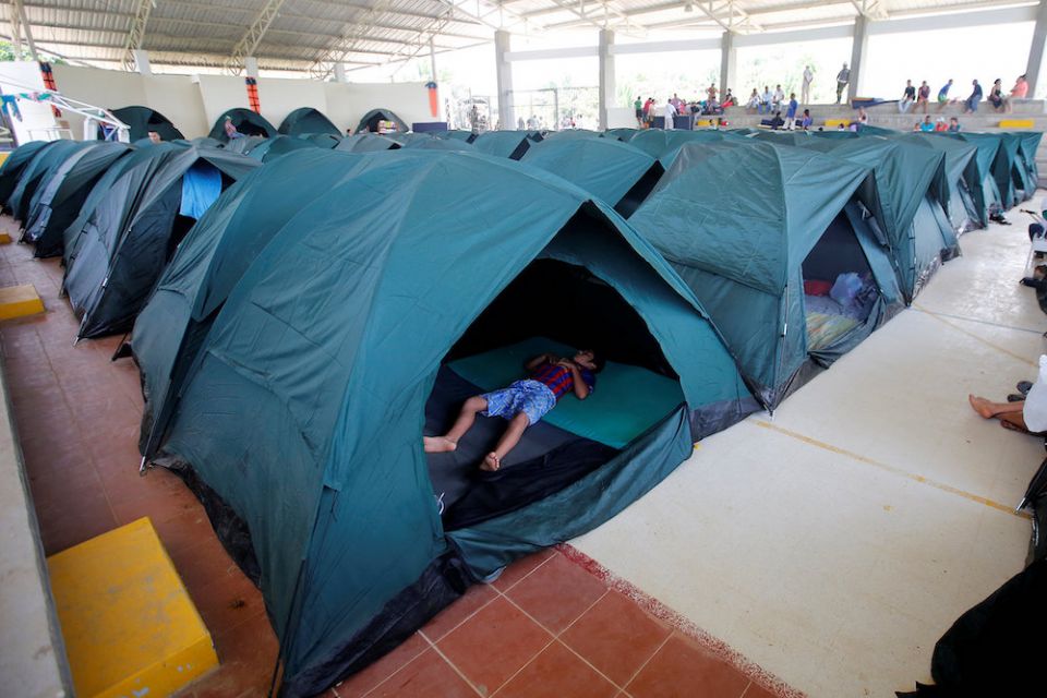 A child sleeps in a tent April 4, 2017, at a shelter for people left homeless after mudslides in Mocoa, Colombia. (CNS/Reuters/Jaime Saldarriaga) A child sleeps in a tent April 4, 2017, at a shelter for people left homeless after mudslides in Mocoa, Colombia. (CNS/Reuters/Jaime Saldarriaga)