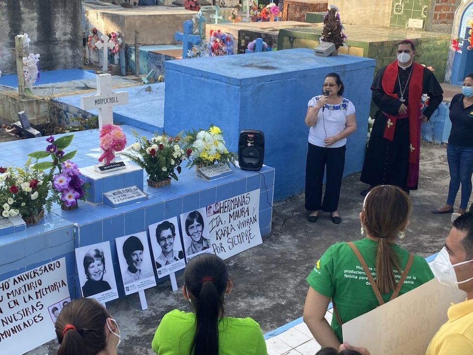 A group of pilgrims gathers near the tomb of Maryknoll Srs. Ita Ford and Maura Clarke on Dec. 1, the eve of the 40th anniversary of their assassination in the Central American nation. (CNS/Rhina Guidos)