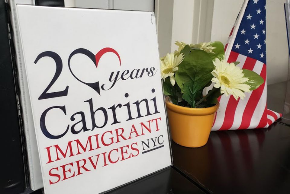 A display in the Lower East Side offices of Cabrini Immigrant Services notes last year's 20th anniversary of the social service agency, which offers a variety of services to immigrants. (GSR photo/Chris Herlinger)