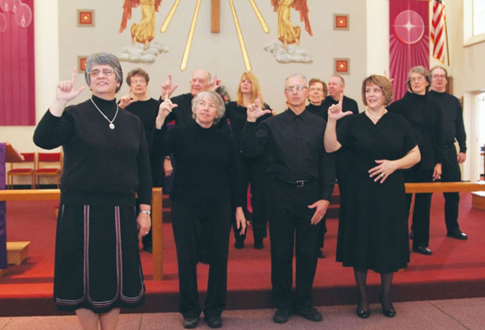 Sr. Conchetta LoPresti, left, signs "Lord" with the sign choir during a 2013 Mass at Resurrection Parish in Cheektowaga, New York. (Courtesy of Sisters of St. Francis of the Neumann Communities)