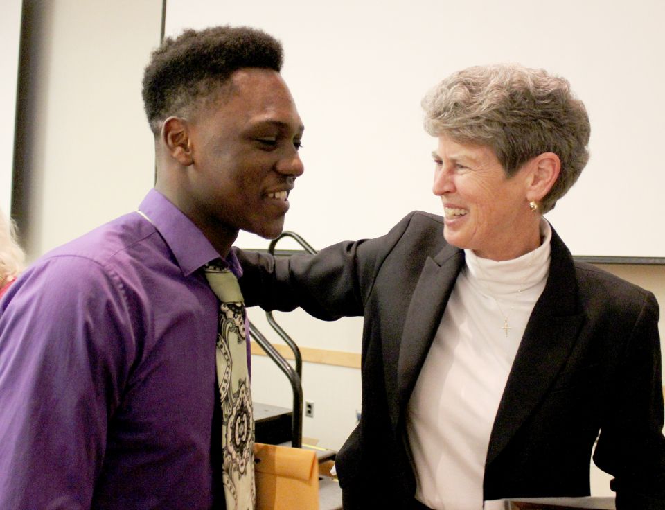 Charity Sr. Sally Duffy congratulates a DePaul Cristo Rey High School student for winning a scholarship in 2016.