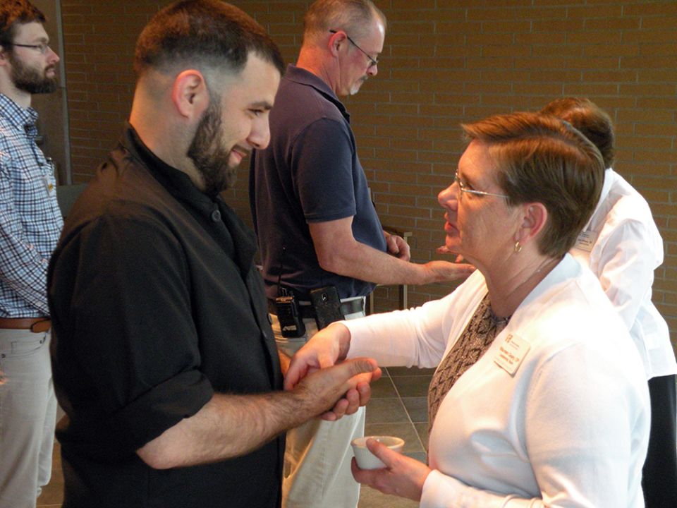 Sr. Maureen Geary blesses the hands of congregational employee Timo Froehlich during the community's 2019 Blessing of the Hands ceremony. (Courtesy of the Grand Rapids Dominicans)