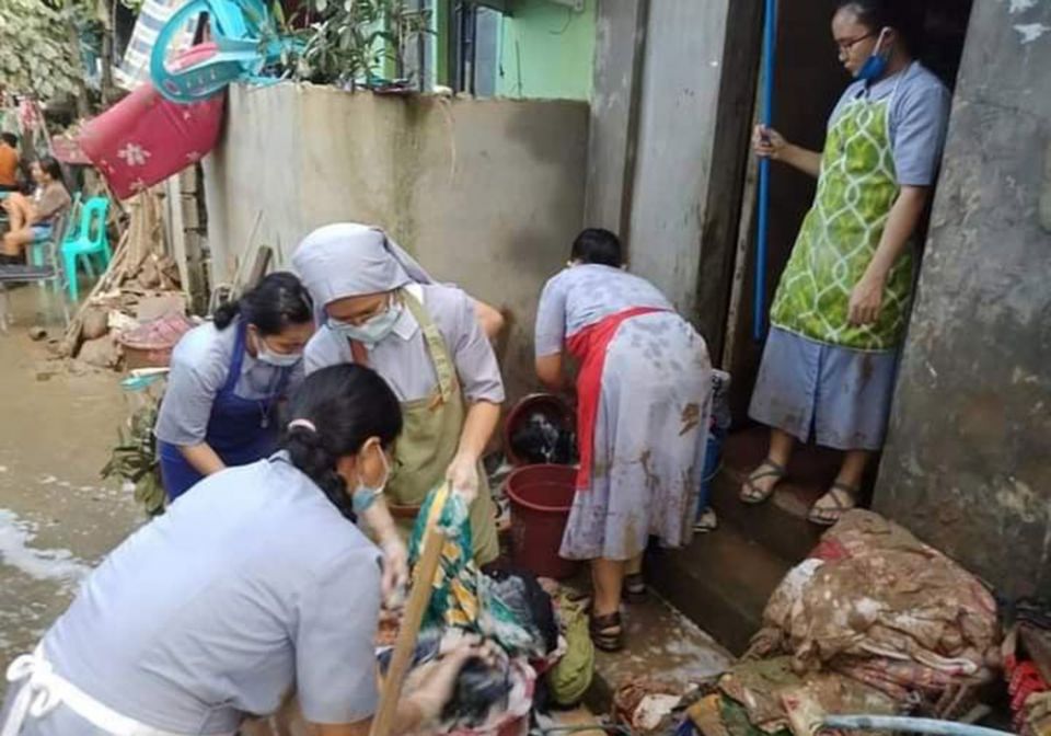 Sister of the Daughters of St. Anne helped residents clean up mud in Bagong Silangan, an area of Quezon City in metropolitan Manila after flooding caused by Typhoon Ulysses, the local name for Typhoon Vamco, which hit the region Nov. 11. (Courtesy of the 