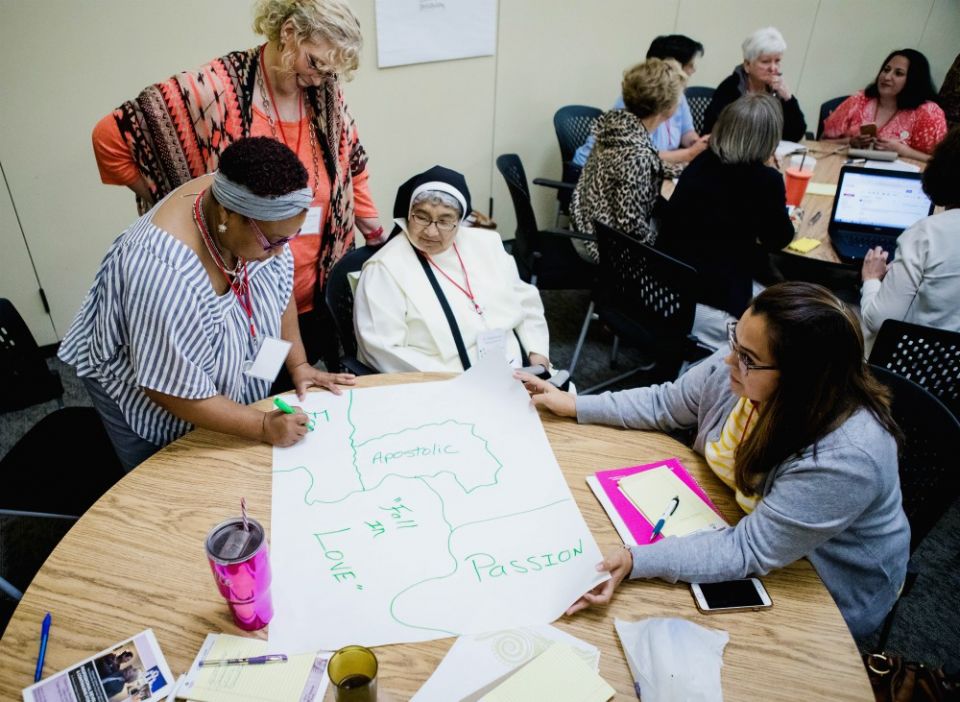 Participants work on a poster at a curriculum workshop for Called and Consecrated in 2018 at the Oblate School of Theology in San Antonio. The curriculum teaches middle and high schoolers about the Catholic faith through the lives of women religious.