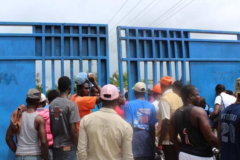 People gather at a border crossing between Haiti and the Dominican Republic.