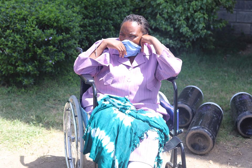 A woman is sitting in a wheelchair as she waits to be attended to by a doctor at St. Joseph Hospital June 2 in Gilgil, in southwestern Kenya. Dr. William Fryda opened the hospital after the fallout between him and the Assumption Sisters of Nairobi over th