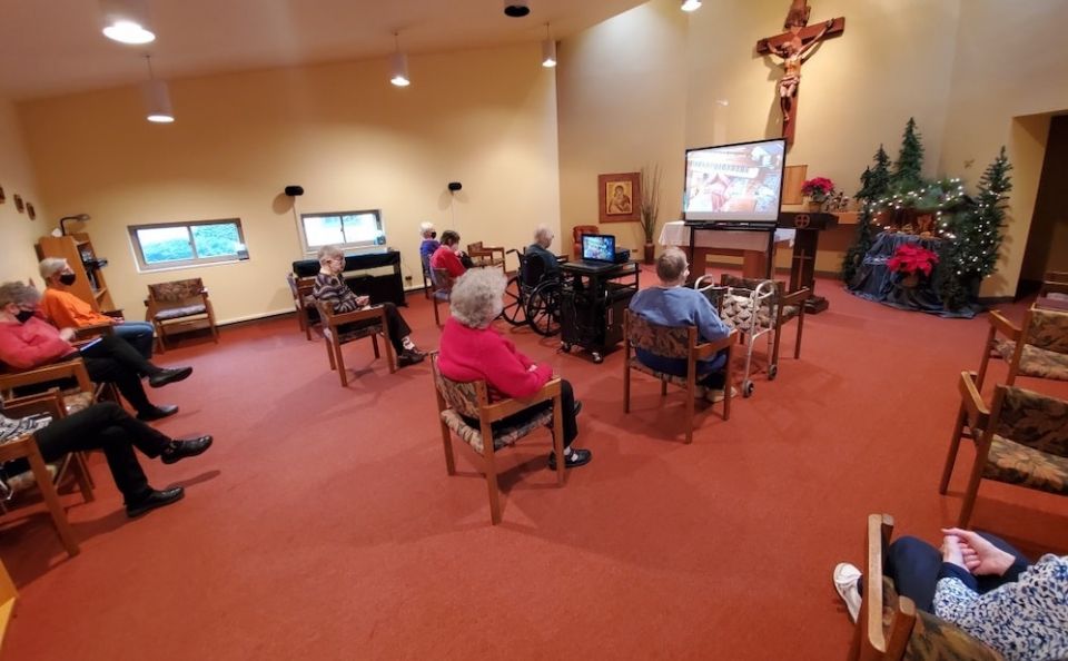 The  Benedictine Sisters of St. Scholastica Monastery in Chicago, Illinois, attend a virtual concert in the chapel in the infirmary wing. One of the community's oblates played piano and sang for the sisters. (Belinda Monahan)