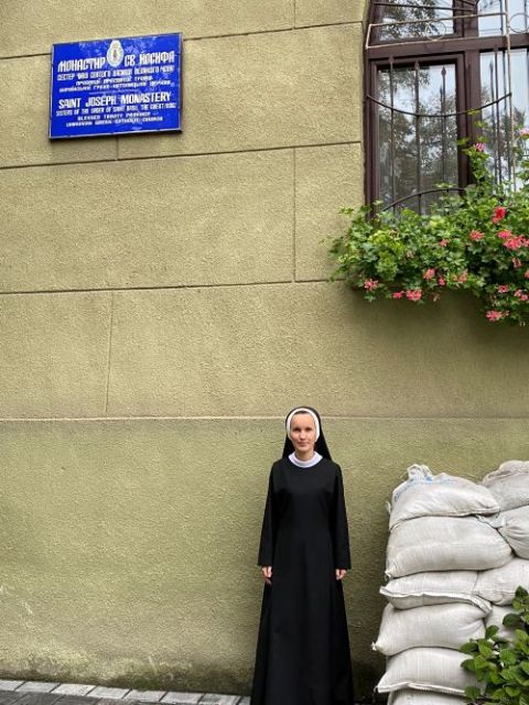 Sr. Josifa Lesnichenko poses next to a pile of sandbags that cover one of the basement windows of St. Joseph's Monastery, Ukraine. (Rhina Guidos)