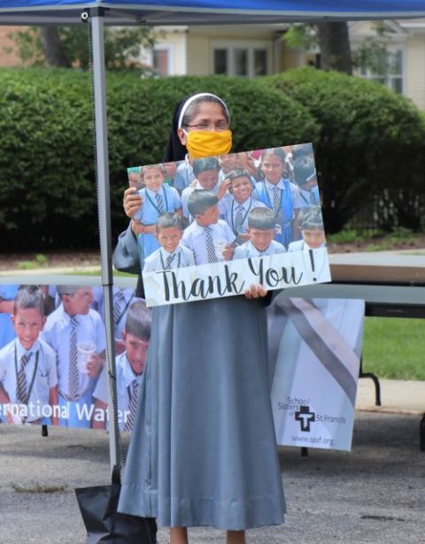 Sr. Lucy Kalapurackal of the School Sisters of St. Francis' international leadership team greets visitors to the community's July 11, 2020, Sister Water Beer Garden in a Box fundraiser. (Courtesy of the School Sisters of St. Francis)
