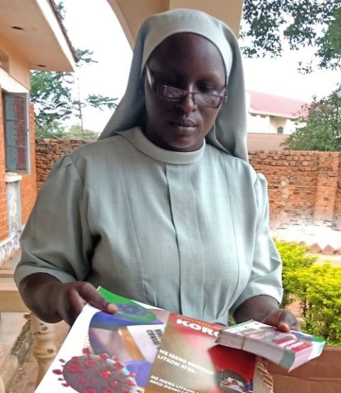 Sr. Winnie Tali of the Missionary Sisters of Mary Mother of the Church displays posters with messages encouraging residents to get vaccinated. The sisters distribute posters and leaflets to ensure people are vaccinated across the country.