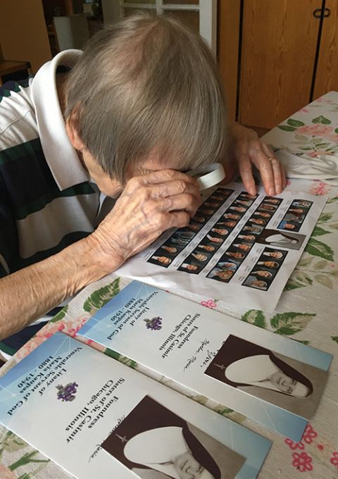 Sr. Jone Sofija Budryte looks at a photo of the Sisters of St. Casimir of Chicago in her kitchen in Vilnius, Lithuania. (Courtesy of the Sisters of St. Casimir)
