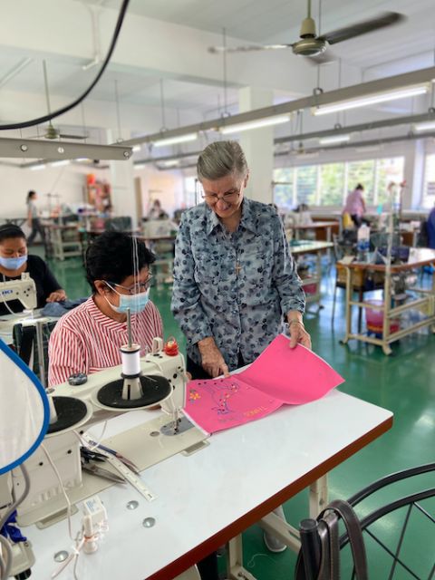 Good Shepherd Sr. Louise Horgan talks to a woman sewing at the Fatima Self Help Centre in Bangkok, Thailand. (Provided photo) Good Shepherd Sr. Louise Horgan talks to a woman sewing at the Fatima Self Help Centre in Bangkok, Thailand. (Provided photo)