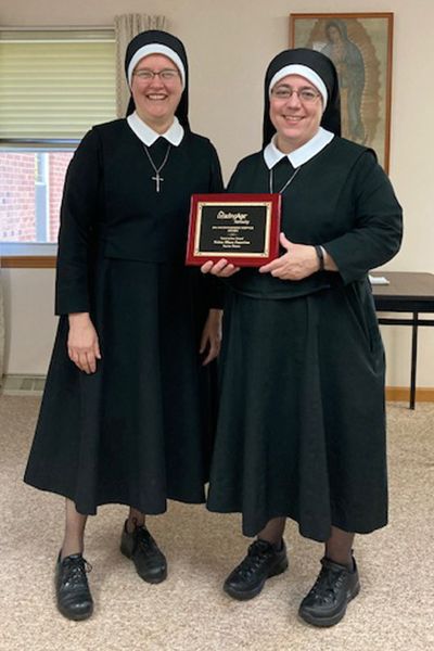 Sr. Mary Faustina Zugelder holds the plaque from Leading Age Kentucky; To her left is Sr. Christina Murray, mother superior of the Sisters of St. Joseph the Worker's motherhouse in Walton, Kentucky. (Courtesy of the Sisters of St. Joseph the Worker) Sr. Mary Faustina Zugelder holds the plaque from Leading Age Kentucky; To her left is Sr. Christina Murray, mother superior of the Sisters of St. Joseph the Worker's motherhouse in Walton, Kentucky. (Courtesy of the Sisters of St. Joseph the Worker)