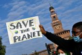 A demonstrator holds up a sign at an Oct. 1 Fridays for Future climate strike in Milan, Italy, ahead of the Oct. 31-Nov. 12 U.N. Climate Change Conference in Glasgow, Scotland. (CNS/Reuters/Flavio Lo Scalzo)
