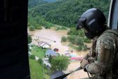 A Kentucky National Guard flight crew from 2/147th Bravo Co. flies over a flooded area in response to a declared state of emergency in eastern Kentucky July 29, 2022. (CNS/Reuters/Sgt. Jesse Elbouab, U.S. Army National Guard)