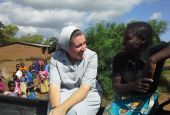 Canossian Sr. Melissa Dwyer and chats with one of her secondary students at Bakhita Secondary School in Balaka, Malawi, in 2009. (Courtesy of Melissa Dwyer)
