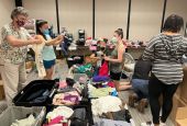 From left: St. Joseph Sr. Louise Ann Micek, Jaesen Evangelista, Emily Michaelis, Emma Shay, Nina Dorsett and Cindy Emenalo. In San Diego, we organized donated clothes for the refugees staying at the migrant hotel.