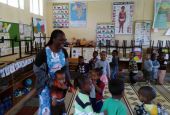 Woman in a Kindergarten room surrounded by children