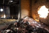 Scattered grain sits inside a warehouse damaged by Russian attacks in Cherkaska Lozova, outskirts of Kharkiv, eastern Ukraine, May 28. (AP photo/Bernat Armangue, File)