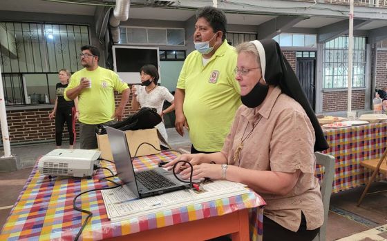 Felician Sr. Maria Louise Edwards (right), Ely Ortiz, president of the Aguilas del Desierto (center) and Aguilas volunteer Maurizio Vitela (left) give a presentation in June at a migrant shelter in Mexico City. (Courtesy photo)